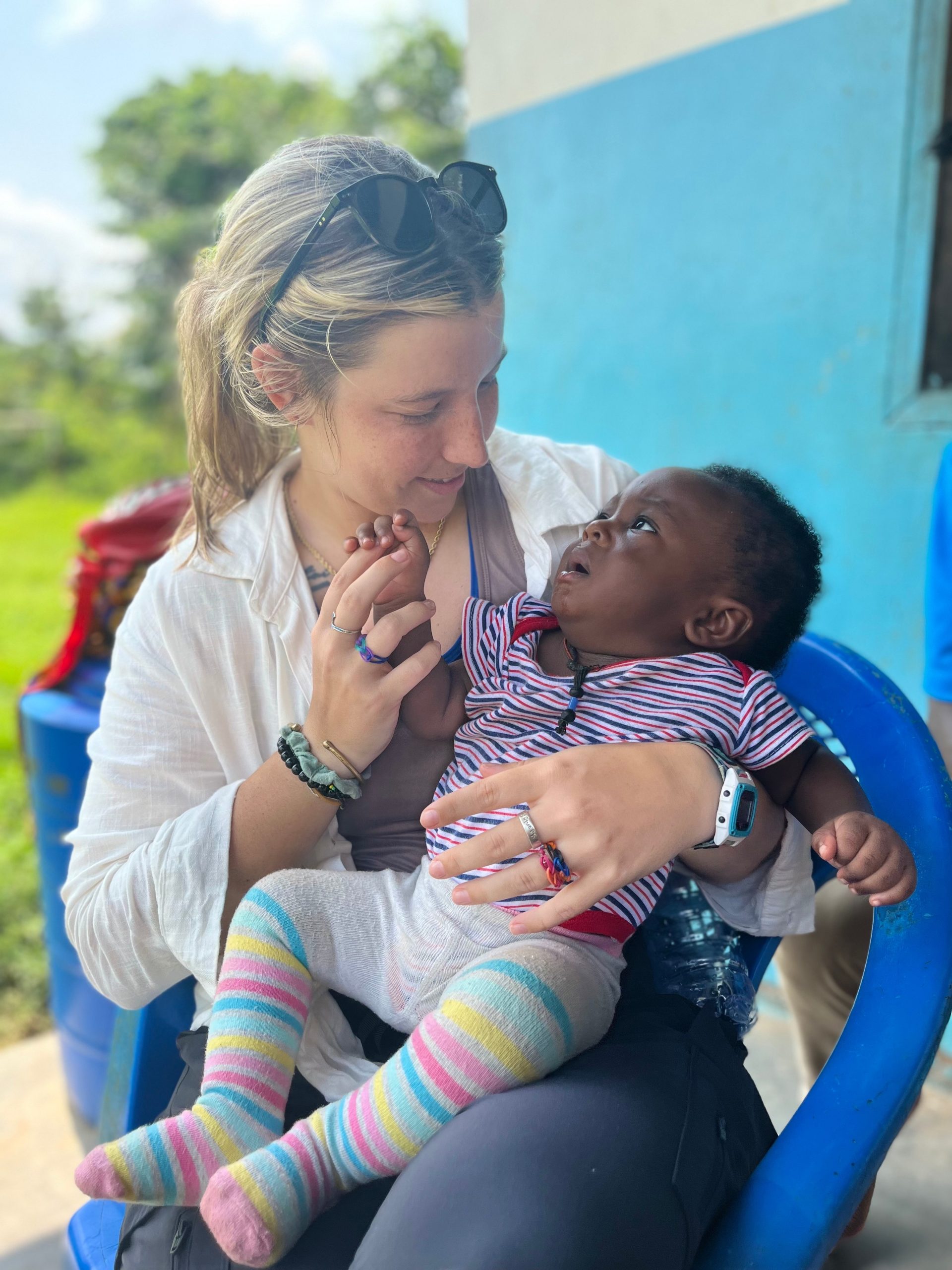 ANF volunteer holding a child in Ghana